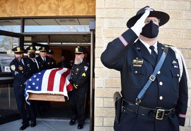 Sgt. Craig Sline from the Homewood police department salutes as the casket of Chicago Heights police officer Gary Hibbs is brought out of St. Kierens Church. A funeral was held for the Chicago Heights officer who suffered a heart attack while on a domestic call. (MC)