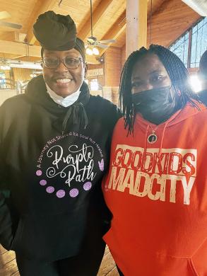 Purple Pathways president Shaniqua Jones, left, and Good Kids Mad City co-founder Camilla Williams helped teens who attended the community conversation event on Sunday, Nov. 21, at Wiley’s Grill in Flossmoor. (Carole Sharwarko/H-F Chronicle)