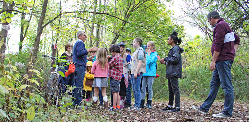 In this photo from 2018, Walk Walton participants listen to a presentation by naturalist Dave Ward. (Chronicle file photo)