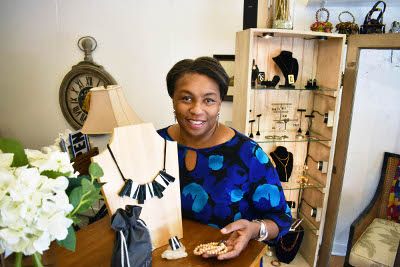 Owner of The Villager Gift Shop, Valerie Warnsby, shows some of the jewelry she sells along with other unique items at her gift shop in Flossmoor.
