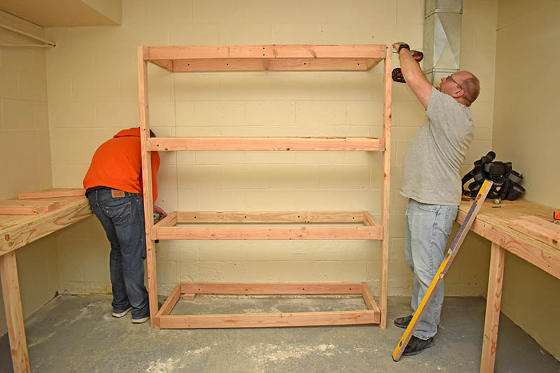 Father and son team Max and David Gilmore volunteer their time to make shelves for a clothing closet inside Overflow Ministry at the Korean United Methodist Church, 19320 Kedzie Ave. in Homewood. Volunteers are accepting donations of like new or new clothing, toiletries and household items. 