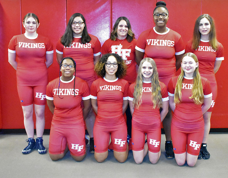 Members of the Homewood-Flossmoor High girls wrestling team are, front row, from left, Stacy Norris, Kris Moore, Diana Martin, Maddy Skowronski and, back row from left, Abby Krakar, Fernanda Vazquez, Coach Jen Olumstad, Jayda Phillips and Savannah Holly.‬ (Donald Crocker/H-F Chronicle)