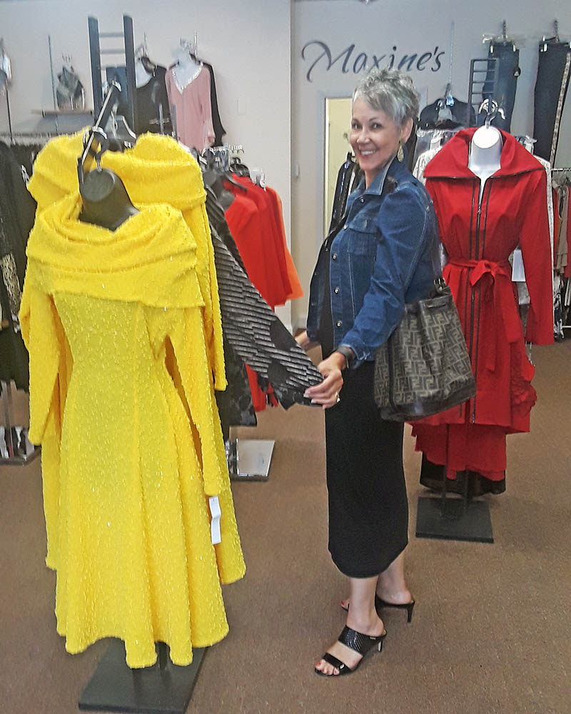 Deverieux Tate, a long time customer who models in Maxine's Fashion Shows, looks over newly arrived styles. (Sharon L. Filkins/H-F Chronicle)