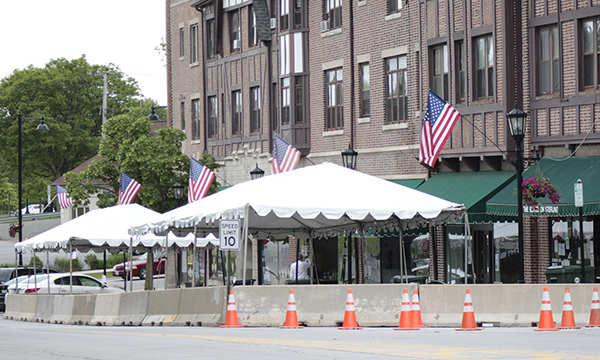 A photo from June 2020 shows the early days of outdoor dining in Flossmoor, started during the pandemic to help restaurants weather the crisis. Flossmoor extended the authorization for outdoor dining, but restaurants will no longer be able to use parking spaces for tables. The reconfiguration of sidewalk space is expected to better accommodate diners. (Chronicle file photo)