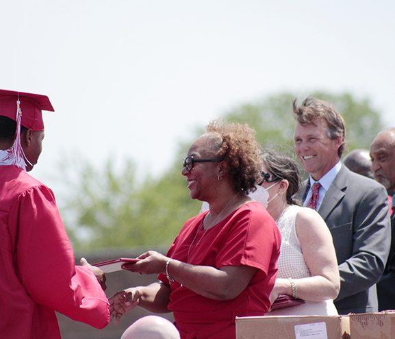 Board of Education member Michelle Hoereth helps present diplomas during graduation on May 29. (EC)