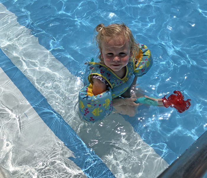 Winnie Trethewey, 3, of Homewood played with her Ariel mermaid doll at the Homewood-Flossmoor Park District's Lions Club Pool on Wednesday. (Marilyn Thomas/H-F Chronicle)