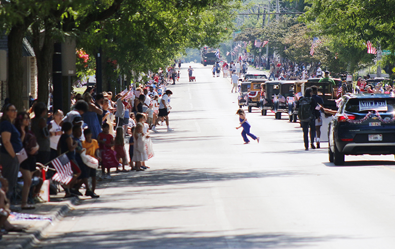 A view looking east on Ridge Road as the first section of the 4th of July parade makes its way to Irwin Park. (EC)