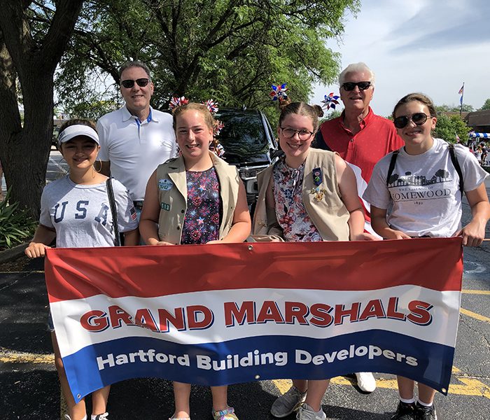 Homewood 4th of July grand marshals Robert Hansen, back row left, and Tim Flanagan, right, of HCF Homewood, are ready to step off for the march through town. They were led by, from left, Gina Bonanotte, Addie Zawaski, Teagan Meeks and Katie Douglas. (MT)