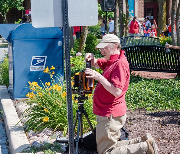 4th_of_July_2022-6 Francis Fullam takes photos of the Flossmoor 4th of July parade. He said he had been coming to the parade for years trying to get the perfect photo. (RBS)