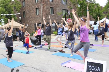 Liz Smith, owner of Serendipity Yoga and Wellness, leads an outdoor yoga session at the 2019 Homewood Artisan Street Fair. Smith is the lead organizer of the Healthy Homewood Festival July 16 on Martin Avenue. (Chronicle file photo)