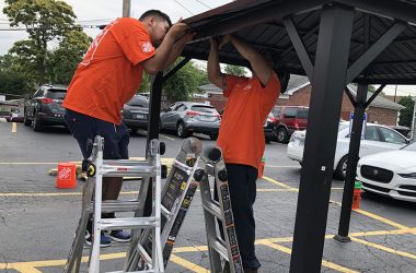 Homewood Home Depot employees Luis Hernandez and Uriel Biurcos assemble a gazebo for the Cancer Support Center. (Marilyn Thomas/H-F Chronicle)