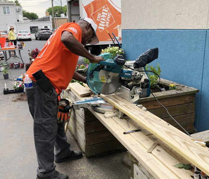 Donardo Jones, an employee at the Home Depot in Homewood, cuts lumber to size for projects at the Cancer Support Center. (Marilyn Thomas/H-F Chronicle)