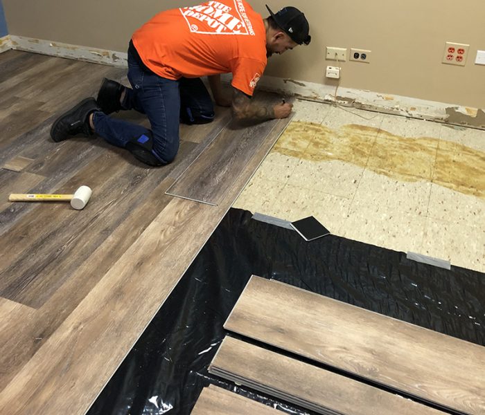 Luis Banuelos, assistant store manager at the Homewood Home Depot, laid a new floor in the kids room at the Cancer Support Center. (Marilyn Thomas/H-F Chronicle)