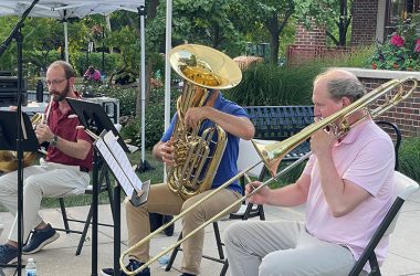 Trombonist Adam Moen performs with an Illinois Philharmonic Orchestra brass quintet Thursday, July 21, outside of the Flossmoor Public Library. (Bill Jones/H-F Chronicle)