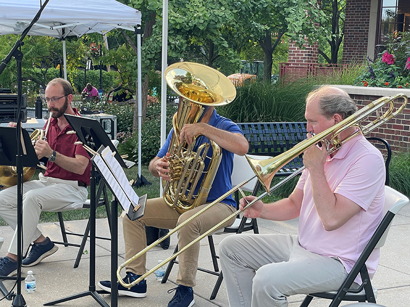Trombonist Adam Moen performs with an Illinois Philharmonic Orchestra brass quintet Thursday, July 21, outside of the Flossmoor Public Library. (Bill Jones/H-F Chronicle)