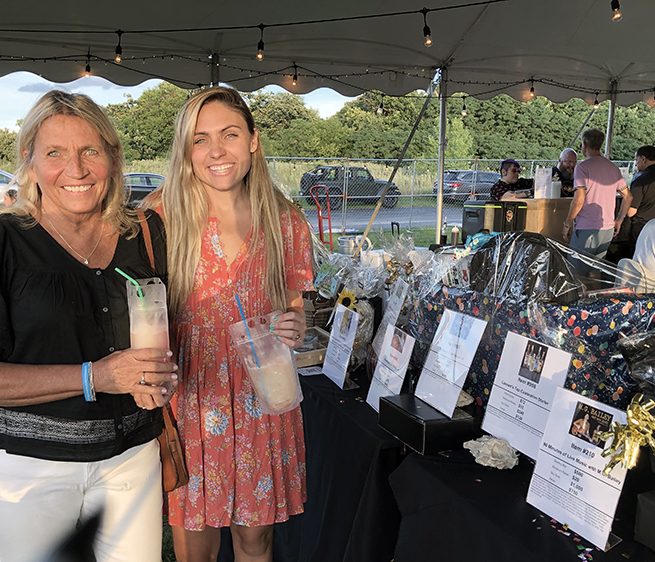 Summer Fest 5 Looking over the auction items at Summer Fest are Kim, left, and Kiki Swanson. (Marilyn Thomas/H-F Chronicle)