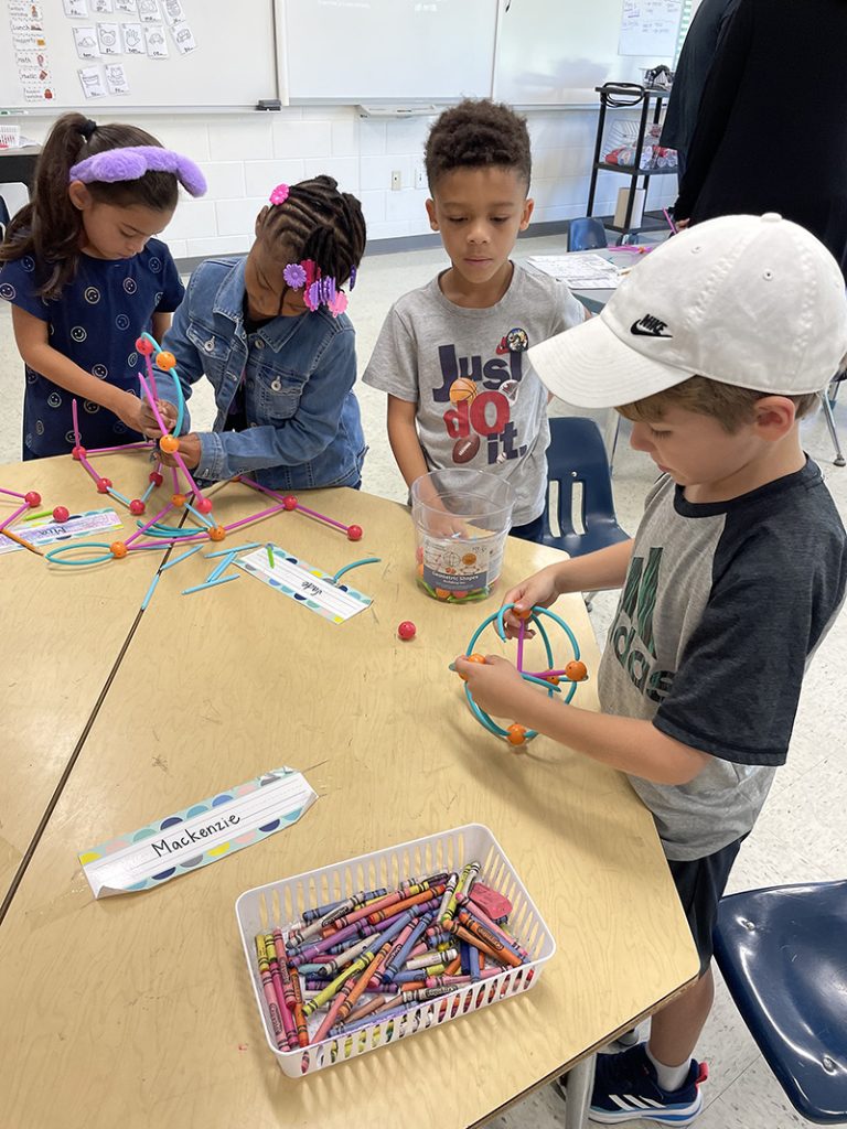 Young Summer Academy students work on a STEM building activity. (Carole Sharwarko/H-F Chronicle)
