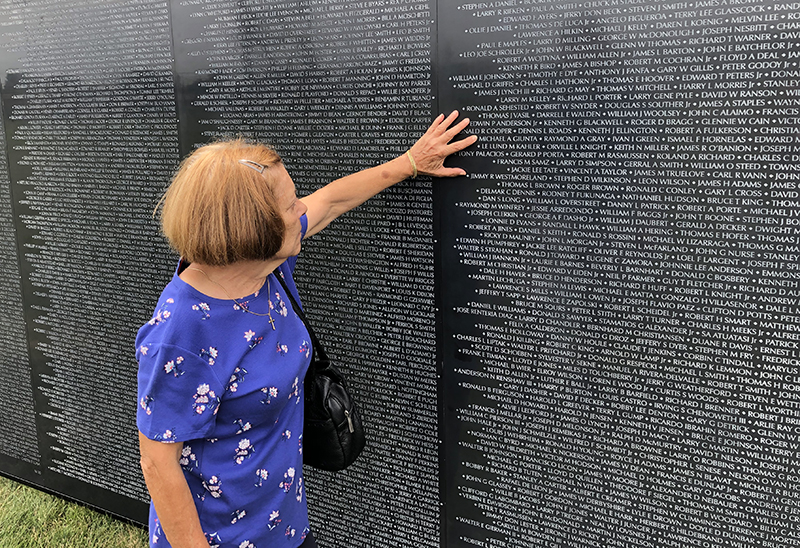 Rose Pease of South Chicago Heights finds the name of her brother, Michael Gunta on the 1969 panel of the Wall That Heals. (Marilyn Thomas/H-F Chronicle)