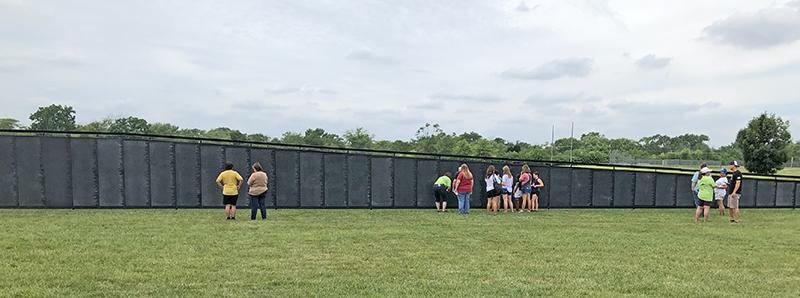 Visitors gather along a section of the Wall That Heals on display through Sunday afternoon at Marian Catholic High School. It is a replica of the Vietnam Memorial in Washington, D.C. (Marilyn Thomas/H-F Chronicle)