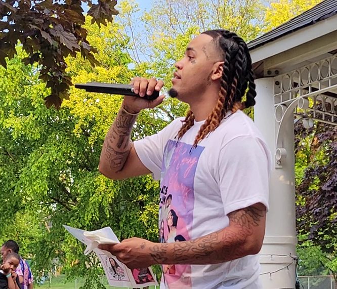 Christian Wilson talks about his relationship with his late sister, Alexis Wilson, during a memorial for her on July 27 at Irwin Park in Homewood. (Eric Crump/H-F Chronicle)