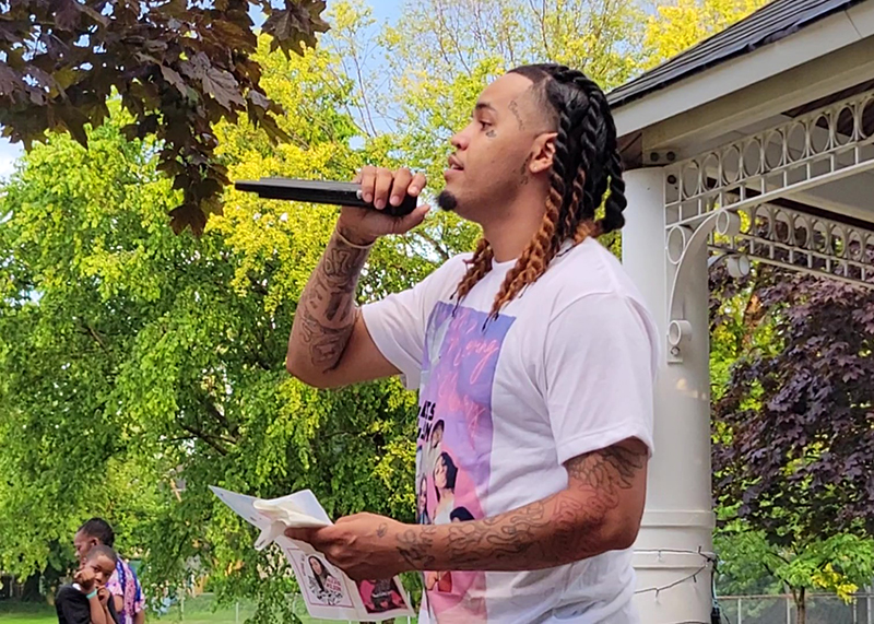 Christian Wilson talks about his relationship with his late sister, Alexis Wilson, during a memorial for her on July 27 at Irwin Park in Homewood. (Eric Crump/H-F Chronicle)