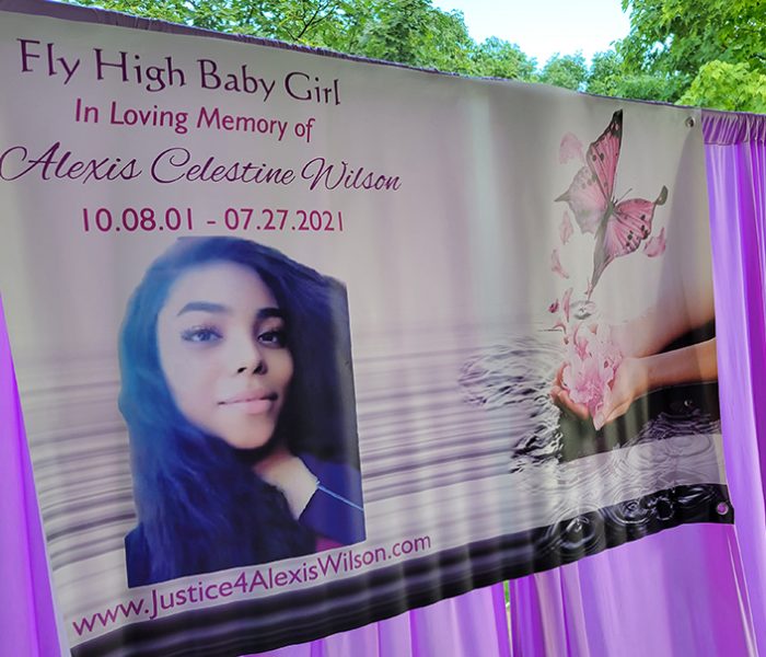 A banner with Alexis Wilson's image is displayed in the gazebo at Irwin Park during a memorial for the H-F High School graduate, who died during an encounter with Dolton police in July 2021.