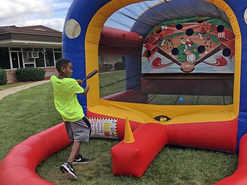 Churchill School fifth grader Caden Hooks got a hit at the baseball game set up during District 153's Back to School event Saturday, Aug. 27. (Marilyn Thomas/H-F Chronicle)
