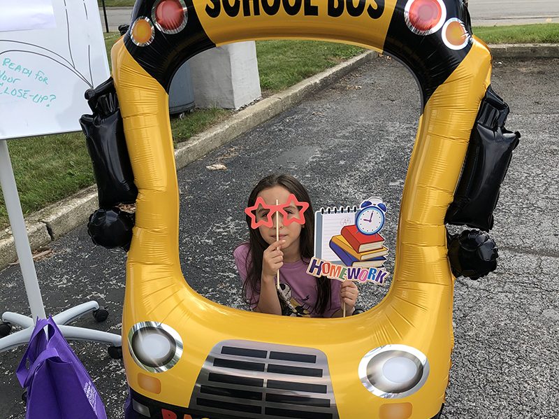 Adalyn Morales, a third grader at Churchill School, poses in the picture frame. (Marilyn Thomas/H-F Chronicle)