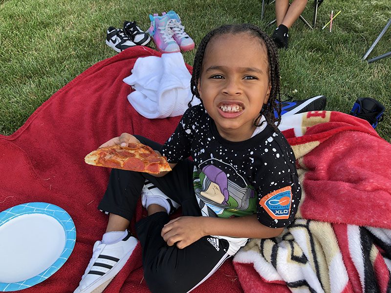 Dawson Kyler's mom treated him with brought pizza at movie night. Dawson will be in kindergarten this year. (Marilyn Thomas/H-F Chronicle)