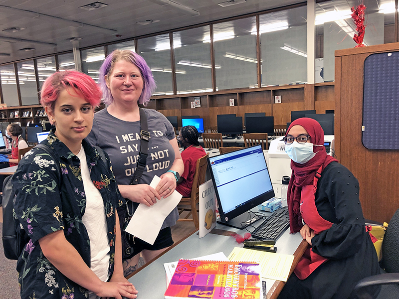 Homewood-Flossmoor High junior Alice Crema, left, with her mom, Brandy Crema, is assisted at registration by Anadeejah Ryan. (Marilyn Thomas/H-F Chronicle)