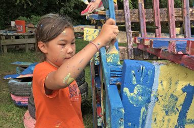 Emilia Leahy gets busy applying blue paint to her team's structure. (Marilyn Thomas/H-F Chronicle)