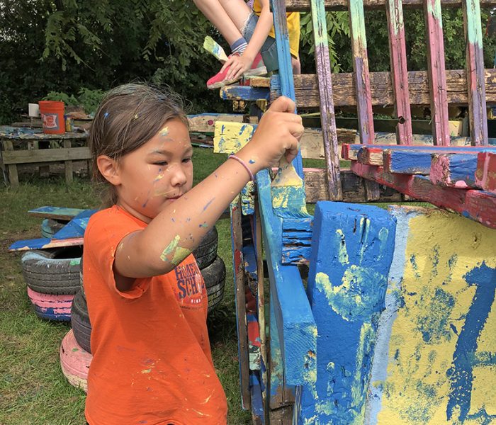 Emilia Leahy gets busy applying blue paint to her team's structure. (Marilyn Thomas/H-F Chronicle)