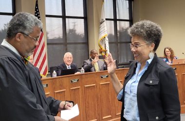 Judge Arthur Willis, left, administers the oath of office to his wife, Julie Willis, as she joins the Homewood Board of Trustees on Tuesday, Aug. 23. Willis was appointed by the board to fill the seat left open by Karen Washington's resignation. (Eric Crump/H-F Chronicle)