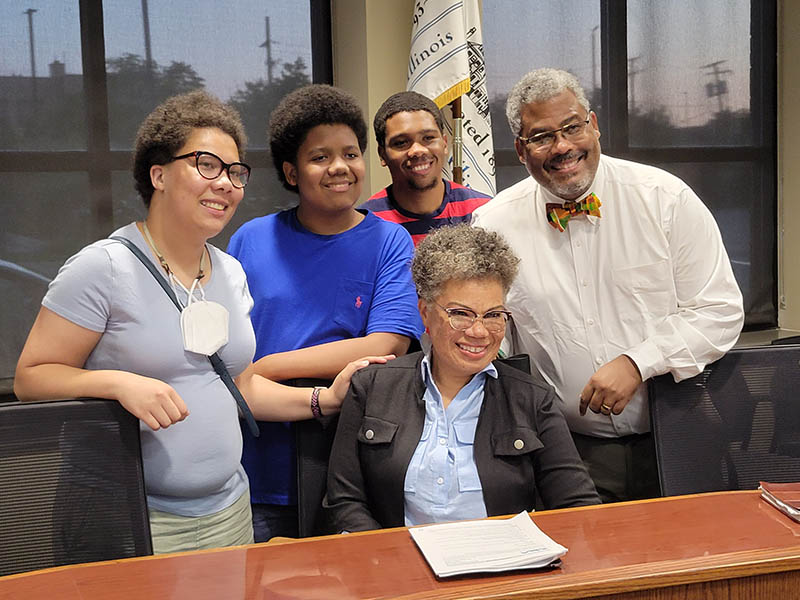 New Homewood Trustee Julie Willis, seated in the center, is surrounded by her family, from left, Samantha, Jackson, A.J. and Arther, after her first meeting on the board. (Eric Crump/H-F Chronicle)