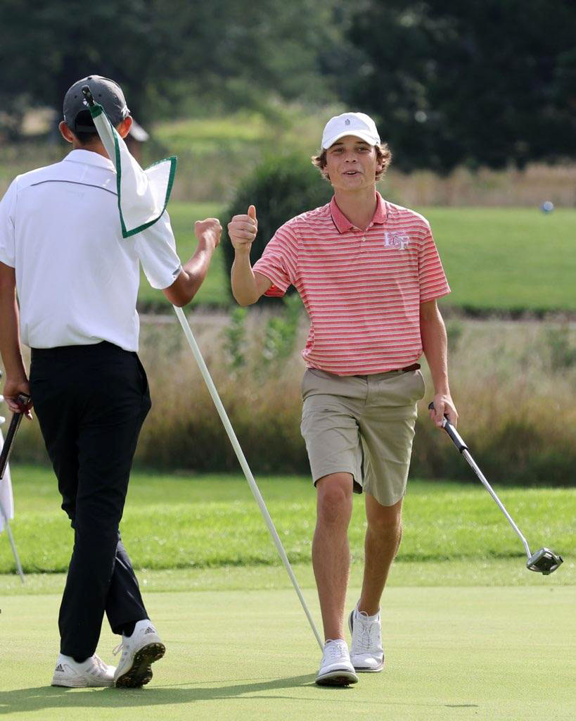 H-F High School's No. 1 golfer, Jack Keigher, gets a fist bump after a shot. (Provided photo)