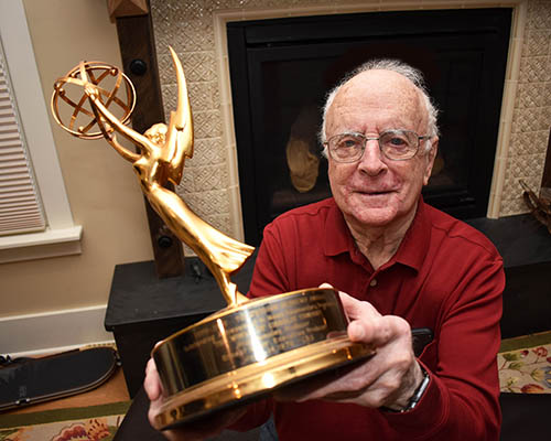 Russ Bensley shows the Emmy Award he received for his work as a news producer. (Chronicle file photo)