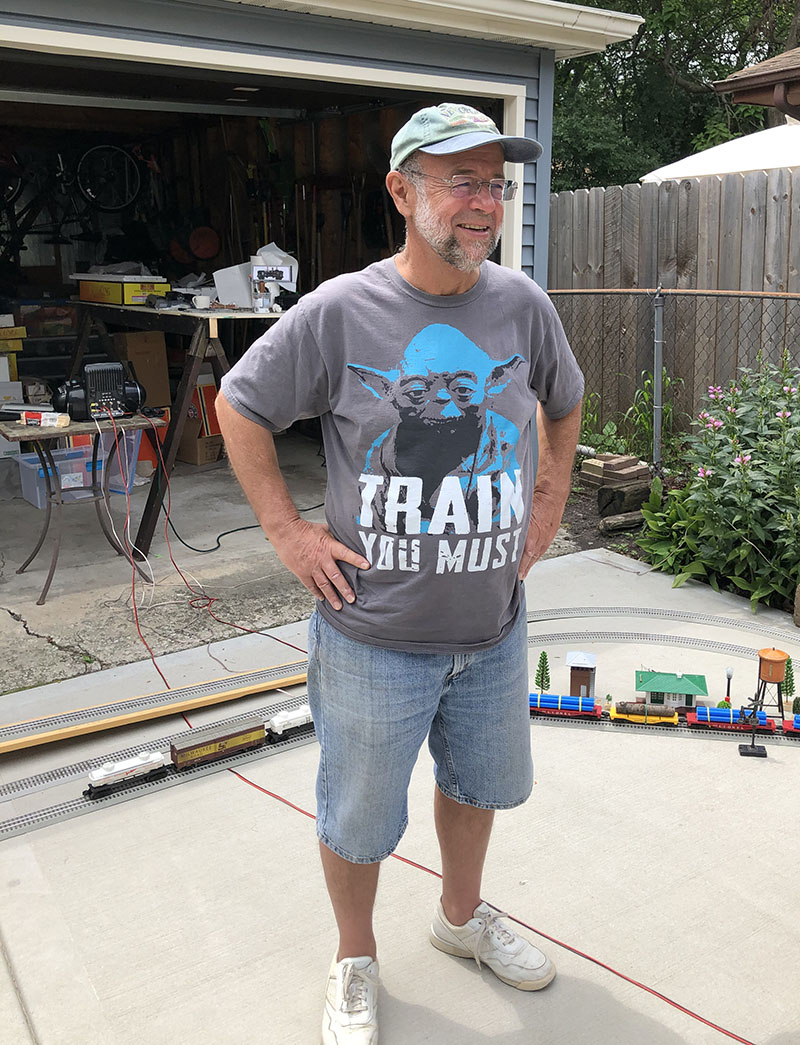 Tom Hentschel of Homewood started his day at 6 a.m. to lay out 450 feet of train for the family's annual model train day at his home. (Marilyn Thomas/H-F Chronicle)