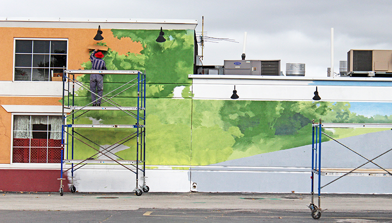 Thomas Melvin is in the early stages of painting "Independence Day" at the end of September 2014. (Eric Crump/H-F Chronicle)
