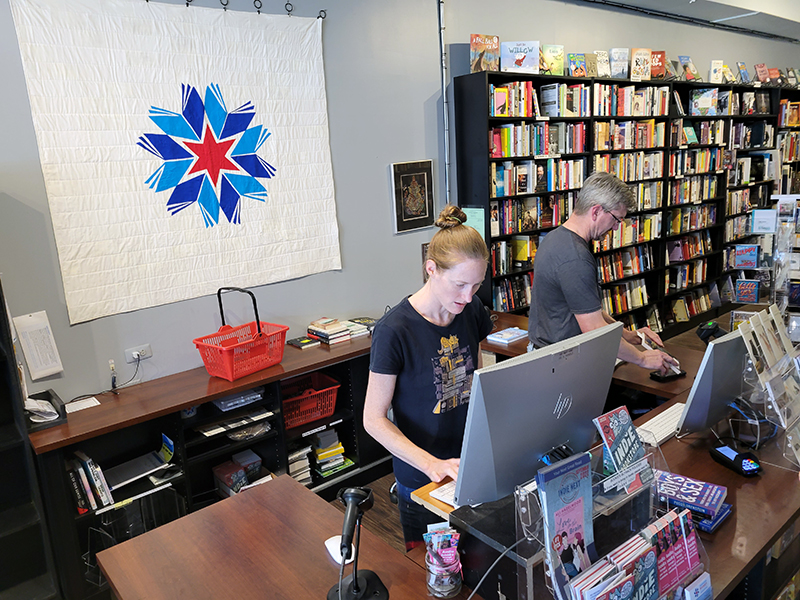 Sarah Jones, left, and store manager Rich Wojcikowski work the desk at Bookie's New and Used Books in Homewood on Saturday. (Eric Crump/H-F Chronicle)