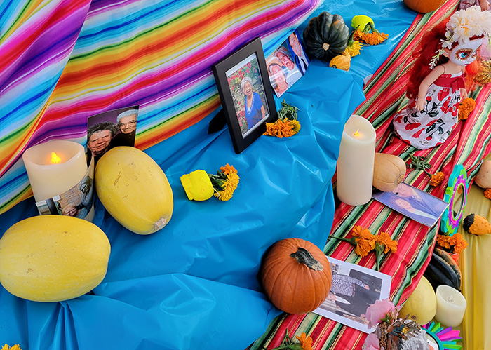 The ofrenda at the 2021 Dia de los Muertos festival is adorned with candles, decorations and photos of lost loved ones. (Chronicle file photo)