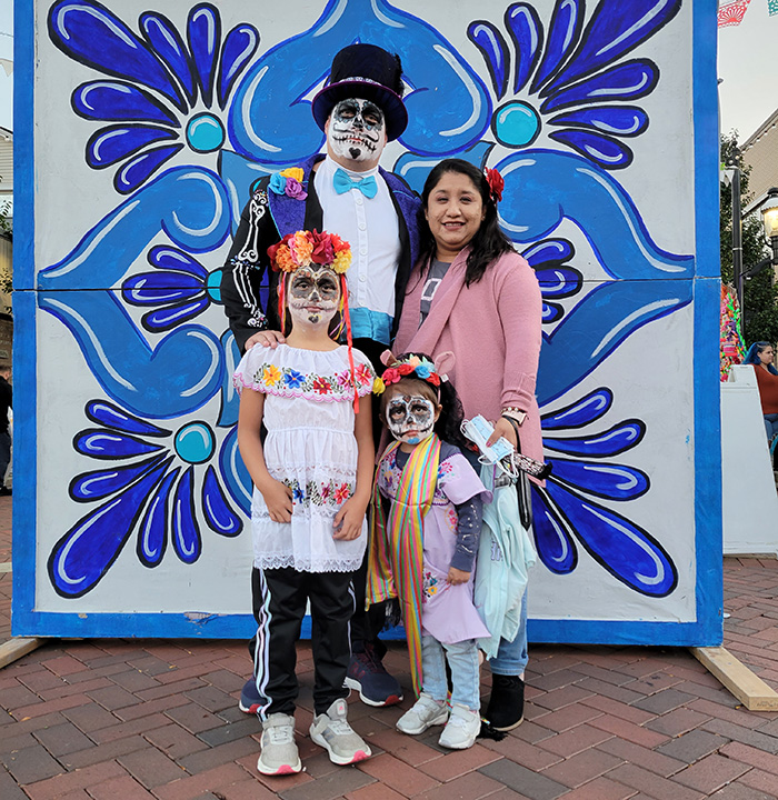 A family dressed and made up in the festival theme pose for a photo during the 2021 Dia de los Muertos event in Homewood. (Chronicle file photo)