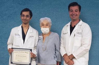 Franciscan Health resident Dr. Nishant Kumar, left, receives the Lowell Goldberg Memorial Scholarship from Dr. Goldberg’s widow Beverly Goldberg and Dr. Tilemahos Spyratos. (Provided photo)
