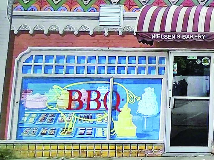 The Sweet Shop mural was designed when a bakery occupied 2053 Ridge Road. After Twisted Q BBQ took over, artist Thomas Melvin added the appropriate image in the shop window, a pig. (Eric Crump/H-F Chronicle)