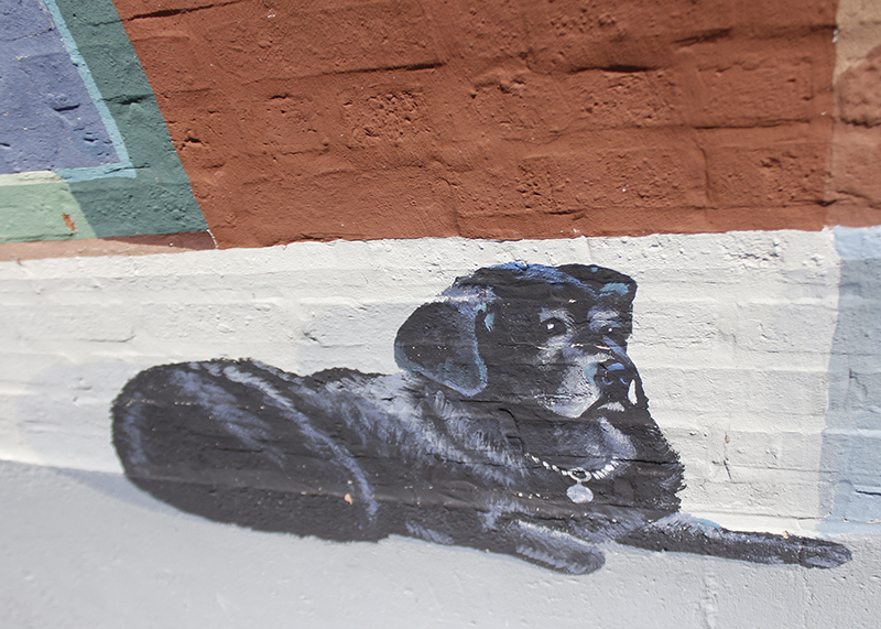 Most of the Haas murals in Homewood have personal touches. In the case of "Service Station" at 18678 Dixie Highway, one of Mayor Rich Hofeld's dogs, Nikki, makes an appearance. (Eric Crump/H-F Chronicle)