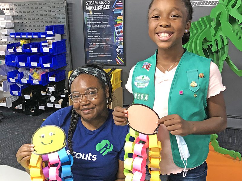 Jauzlyn Hardy, seated, program manager for Girl Scouts of Greater Chicago and Northwest Indiana, worked with scout Tristin Terrell on craft projects at the Homewood Science Center. (Marilyn Thomas/H-F Chronicle)