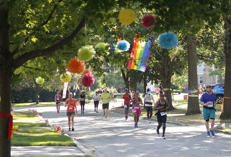 Runners enjoy the shade and colorful decorations as they make their way through the Flossmoor Park neighborhood during the Hidden Gem Half Marathon. (Eric Crump/H-F Chronicle)