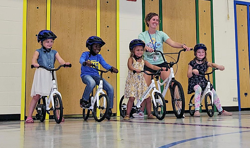 Teacher Jodi Klyn with young bikers, from left, Lila Klein, Brendan Barber, Addison McNeil and Hazel Klein. The All Kids Bike program is being used at Willow School in Homewood to teach kindergarteners how to ride a bike. (Eric Crump/H-F Chronicle)