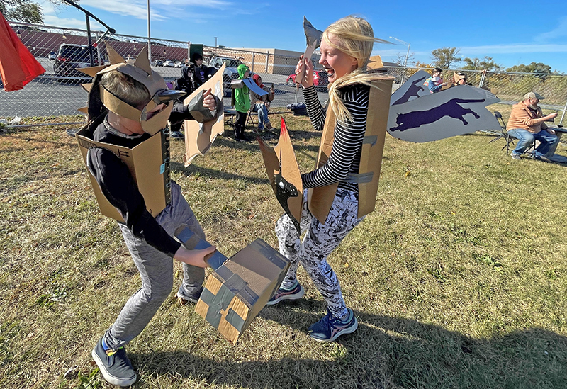 Jon and Addie Kempe, of Homewood, do battle the afternoon of Saturday, Oct. 15, in the Beer Field outside of Rabid Brewing in Homewood. The brewery held a cardboard costume and weapons parade and subsequent Box Battle Basho as part of its five-year Rabidaversary. (Bill Jones/H-F Chronicle)