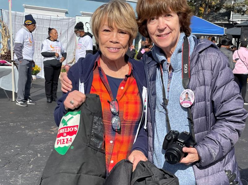 Sue Aurelio, left, stands with Barb Nevins after delivering complimentary pizza for all the walkers. (Carole Sharwarko/H-F Chronicle)