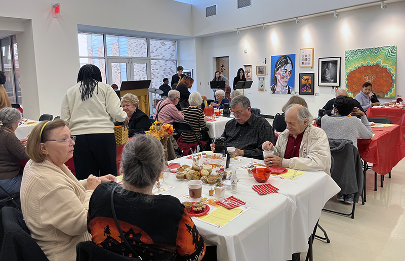 Senior citizens eat breakfast as guests of Homewood-Flossmoor High School while Miyako, a jazz ensemble that consists of H-F students, performs in the background. (Nick Ulanowski/H-F Chronicle)
